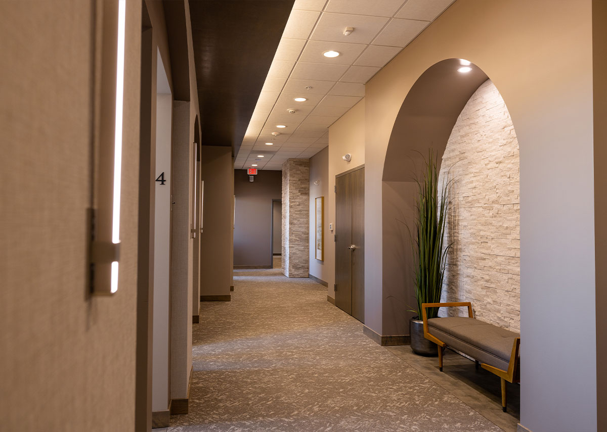 Waukee Dental hallway with arch and stone walls